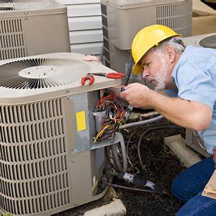 Technician repairing AC condenser unit