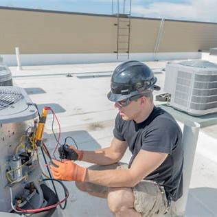 HVAC technician working on indoor unit